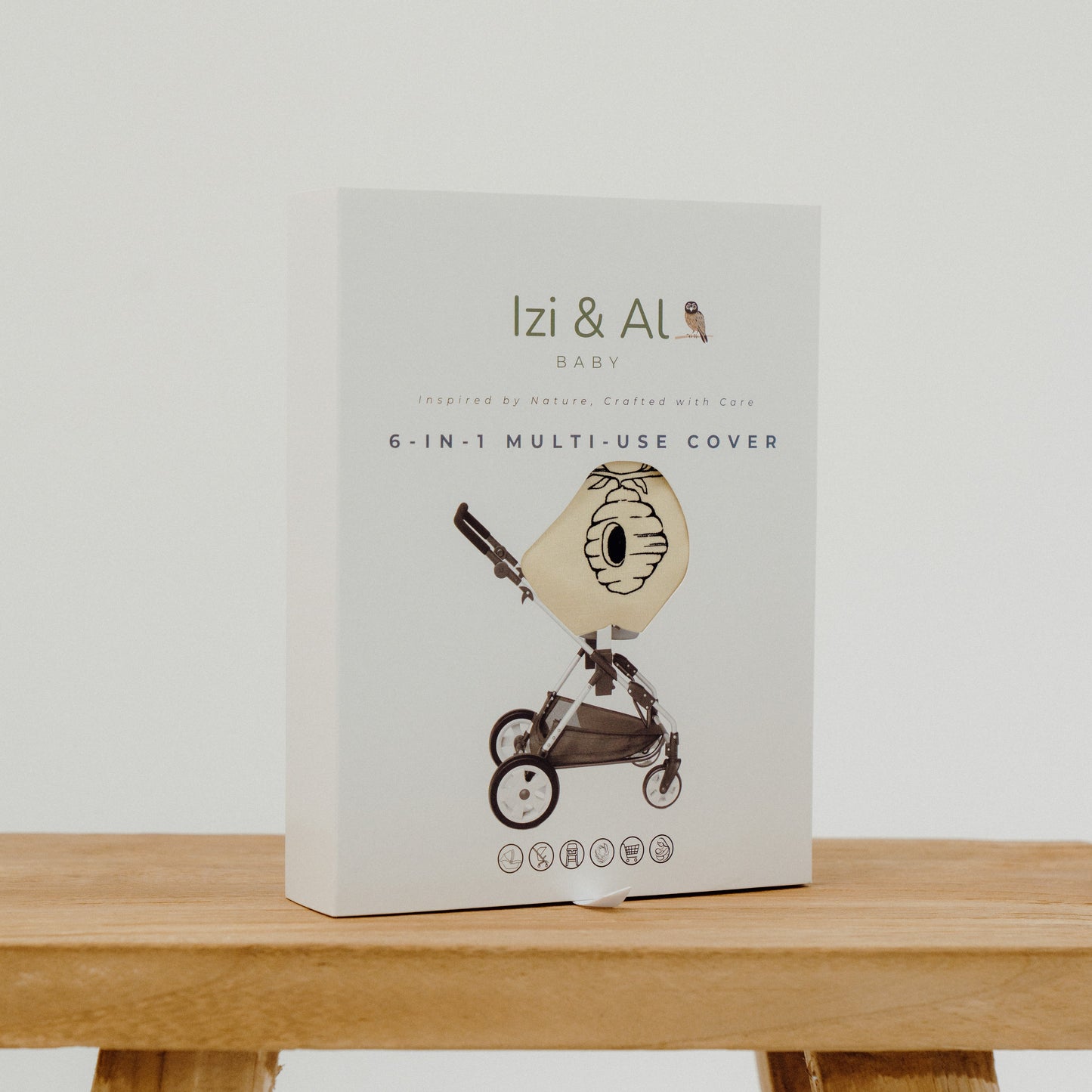Package of 'Izi & Al' 6-in-1 multi-use cover on a wooden surface with a white background