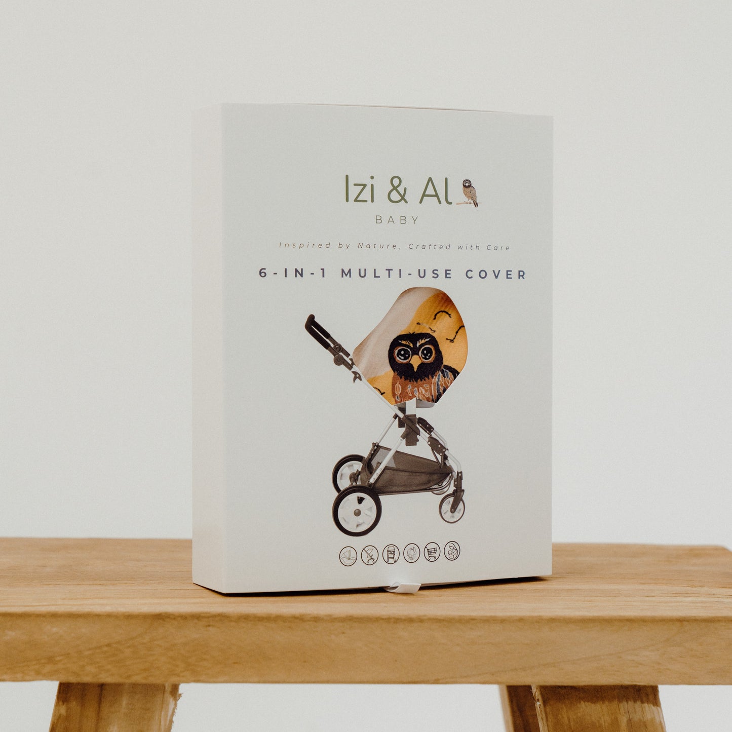 Izi & AL baby product packaging on a wooden surface with a white background