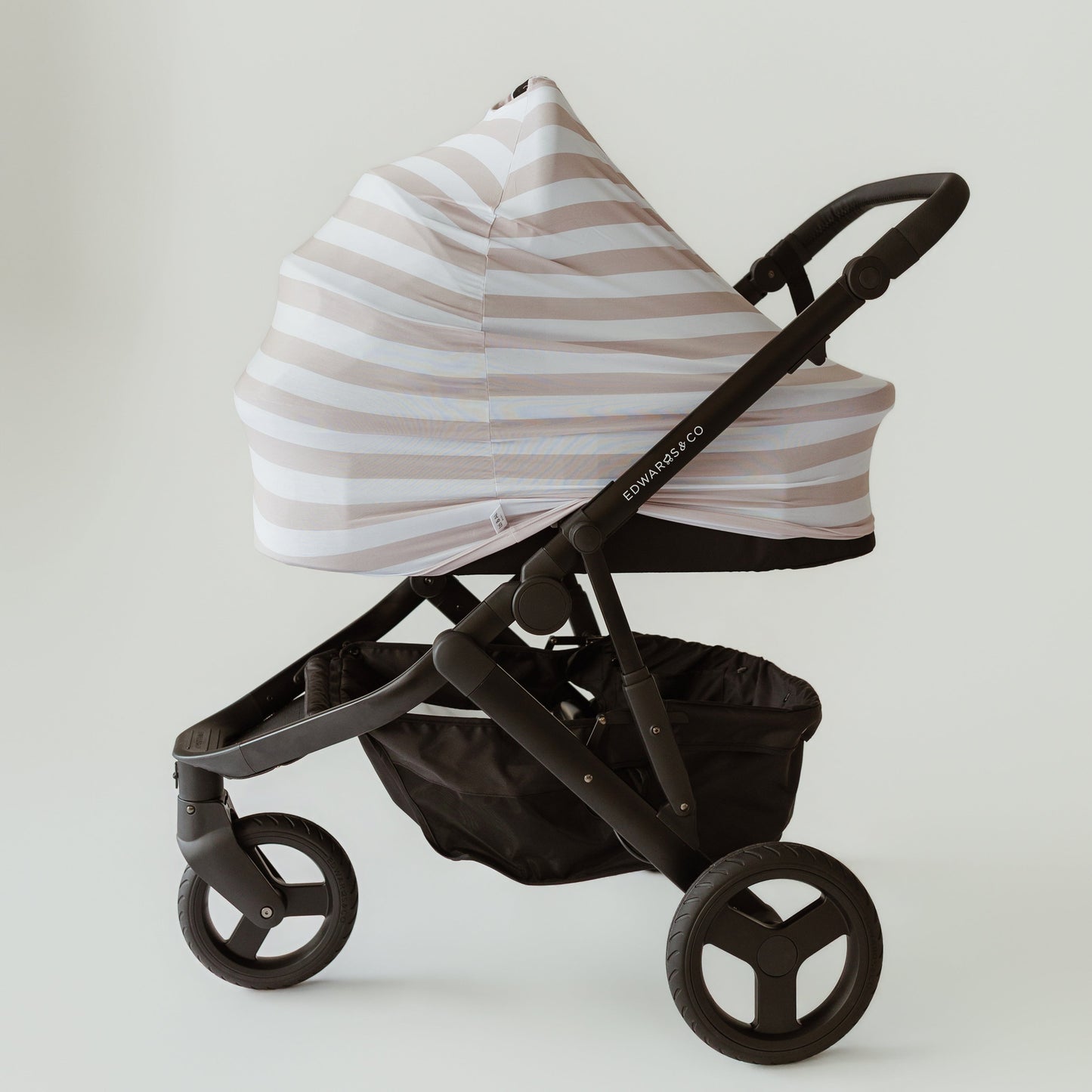 Seashell Stripe beige bamboo baby cover on a pram bassinet by Izi & Al