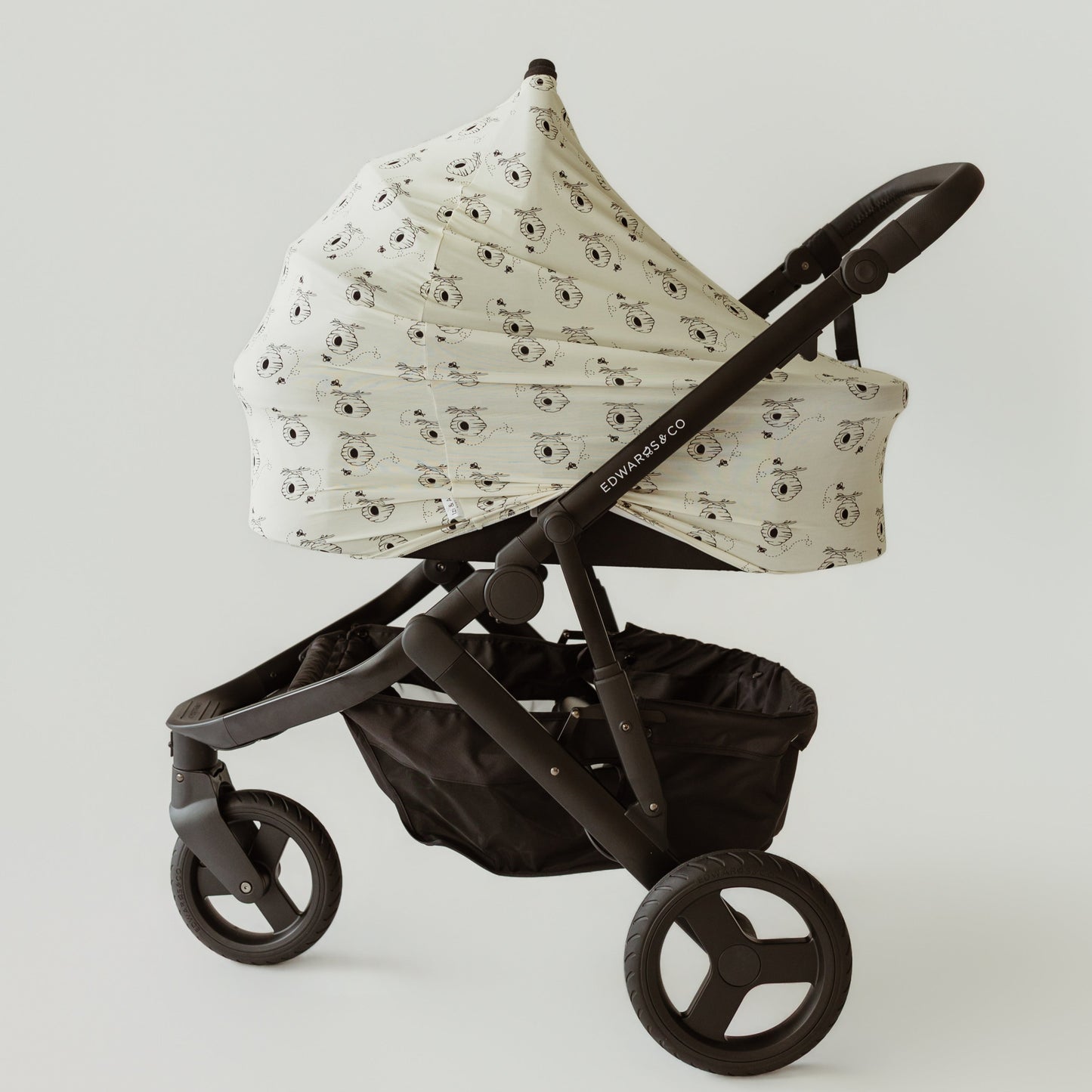 Honey & Hive yellow bamboo baby cover on a pram bassinet by Izi & Al