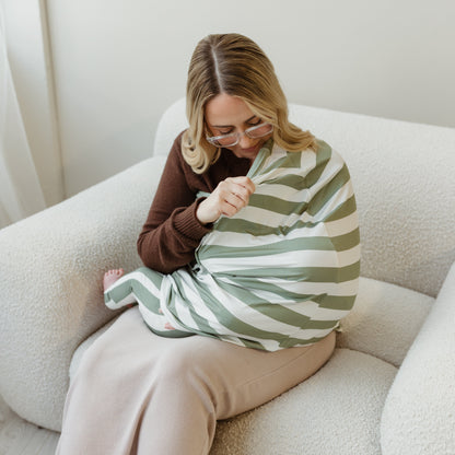 Mum breastfeeding with Sage Stripe bamboo nursing cover for privacy by Izi & Al