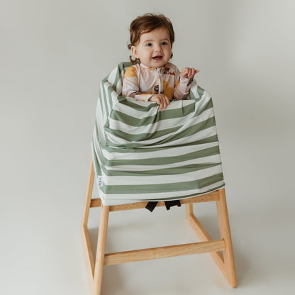 Baby in high chair using Sage Stripe bamboo cover as a high chair cover by Izi & Al